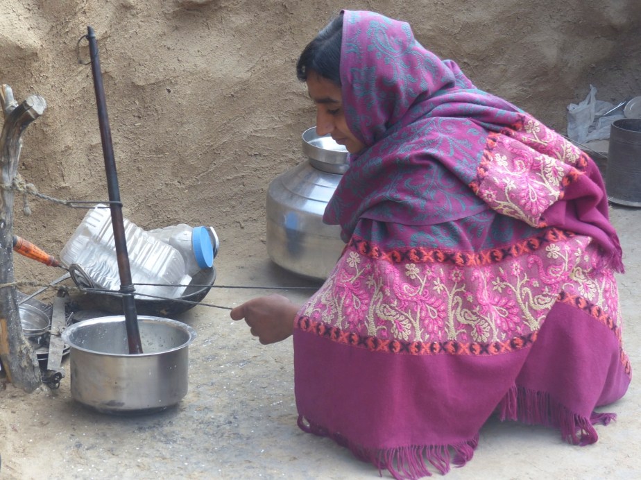 A Bishnoi woman thickening milk.